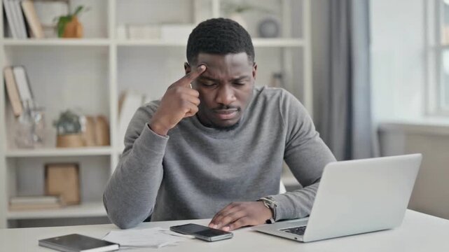 Deep Thought at Desk: A focused individual, immersed in thought, sits at a desk, grappling with complex problems amidst modern technology, illustrating the intense effort of contemplation.
