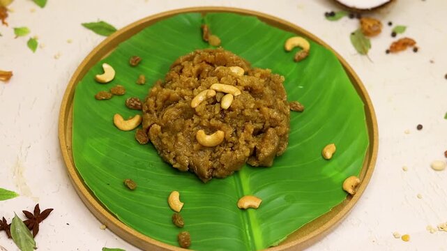 Moong dal halwa indian dessert with dry fruits on banana leaf