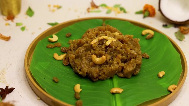 Moong dal halwa indian dessert with dry fruits on banana leaf