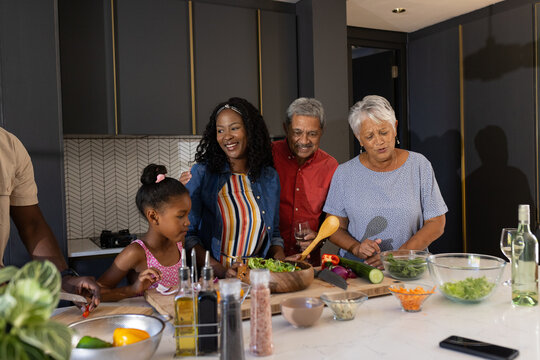 Preparing meal together, three generations of African American family in kitchen