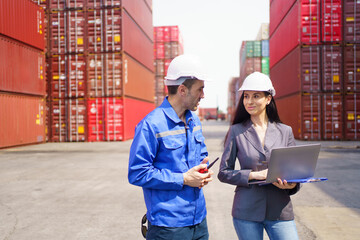 Fototapeta premium Businesswoman talking with container yard officer about import export logistics, global trade, and international shipping management.