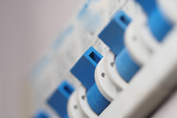 Close-up view of blue switches on a control panel