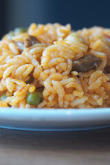 Delicious rice dish with vegetables and meat on a plate