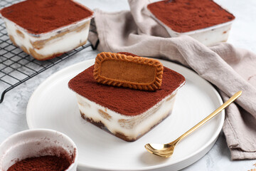 Tiramisu dessert box on a white plate.