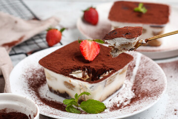 Tiramisu dessert box on a white plate.