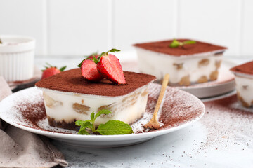 Tiramisu dessert box on a white plate.