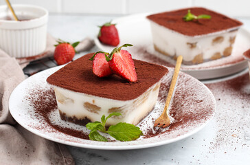 Tiramisu dessert box on a white plate.