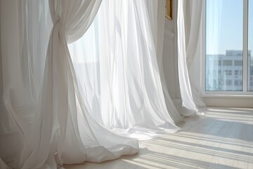 White sheer curtains billowing by a window