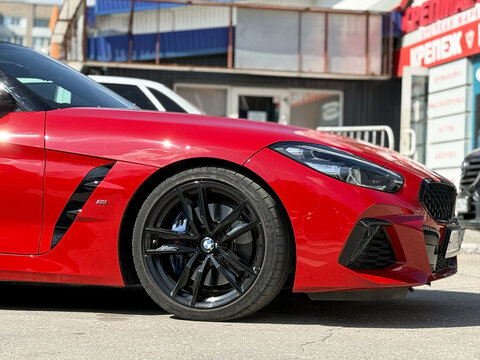 BMW Z4 M40i III (G29) red color parked on street. Exterior of red BMW Z4 M40i III (G29) sport coupe manufactured by the German automobile manufacturer on parking lot.
