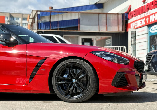 BMW Z4 M40i III (G29) red color parked on street. Exterior of red BMW Z4 M40i III (G29) sport coupe manufactured by the German automobile manufacturer on parking lot.