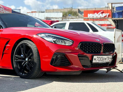 BMW Z4 M40i III (G29) red color parked on street. Exterior of red BMW Z4 M40i III (G29) sport coupe manufactured by the German automobile manufacturer on parking lot.