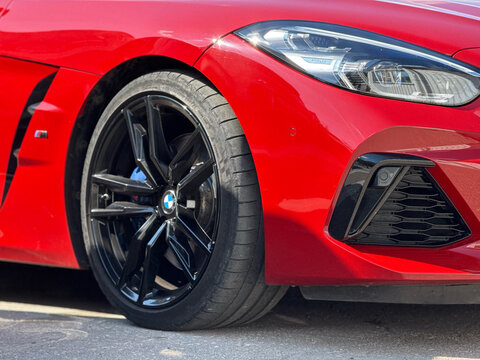 BMW Z4 M40i III (G29) red color parked on street. Exterior of red BMW Z4 M40i III (G29) sport coupe manufactured by the German automobile manufacturer on parking lot.
