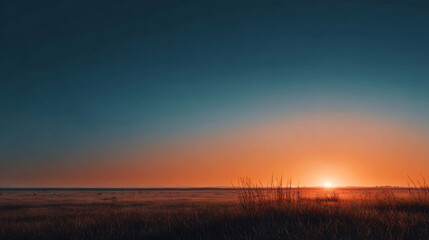 empty grassland stretching to horizon with rich orange sunset light, subtle color gradient in clear sky, minimalist evening landscape with lots of blank space
