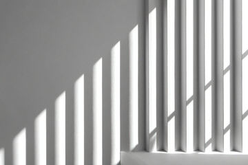 Obraz premium Sunlight casts diagonal shadows through vertical blinds onto a white wall, creating a minimalist and geometric pattern with contrasting light and shadow