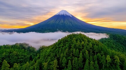 Fototapeta premium Majestic Mount Fuji at Sunrise Surrounded by Lush Green Forest and Soft Fog