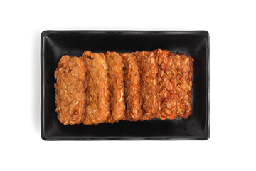Tempe. Fried tempeh isolated on white background. fermented soy bean.