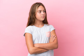 Fototapeta premium Little caucasian girl isolated on pink background looking to the side