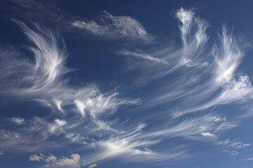 Wispy, flowing clouds against a deep blue sky