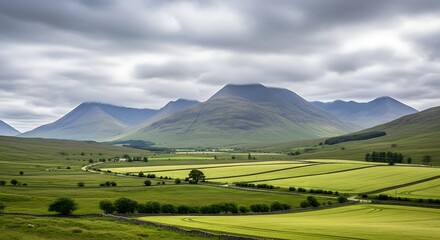 Naklejka premium Dramatic cloudy sky over a vast green mountain valley in Scotland.