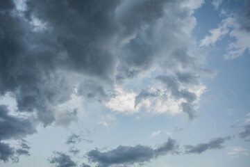 White fluffy clouds scattered across a deep blue sky creating a bright and airy weather background with natural light