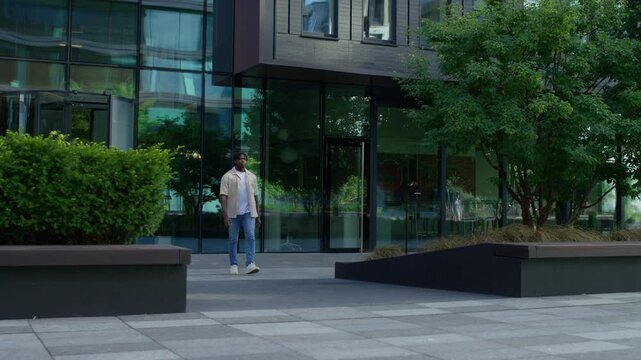 Young man walking outdoors in modern city