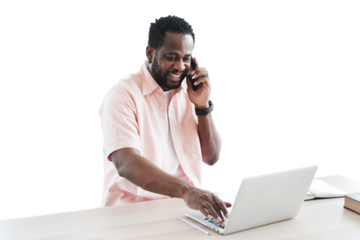 African American businessman using and talking smartphone for online working with laptop on desk