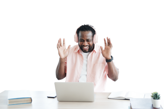 African American businessman listening to music with headphone and online working with laptop