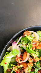 Salad with crispy chicken wings. Asian cuisine.