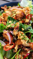 Salad with crispy chicken wings. Asian cuisine.