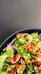 Salad with crispy chicken wings. Asian cuisine.