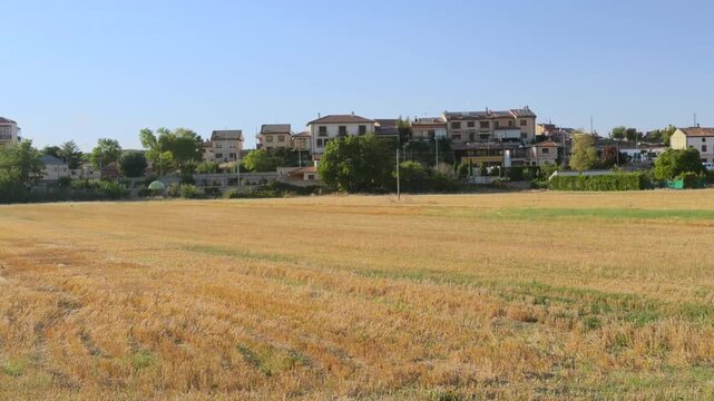 El Burgo de Osma skyline beyond harvested wheat field