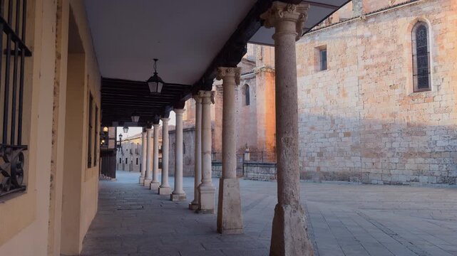 Sunlight illuminating El Burgo de Osma arcade in Spain