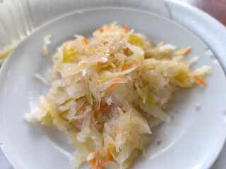 Homemade sauerkraut in a white plate.