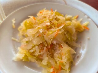 Homemade sauerkraut in a white plate.