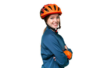 Young cyclist woman over isolated chroma key background with arms crossed and looking forward