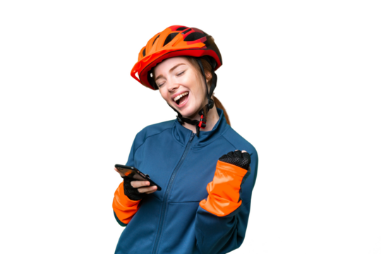 Young cyclist woman over isolated chroma key background with phone in victory position - Powered by Adobe