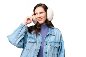 Young caucasian woman wearing winter muffs over isolated background having doubts and with confuse face expression