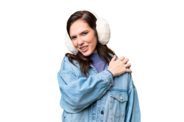 Young caucasian woman wearing winter muffs over isolated background suffering from pain in shoulder for having made an effort