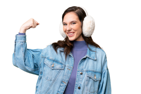 Young caucasian woman wearing winter muffs over isolated background doing strong gesture