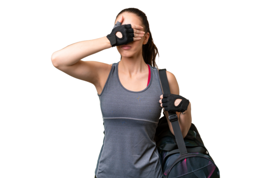 Young sport woman with sport bag over isolated background covering eyes by hands. Do not want to see something - Powered by Adobe