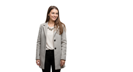 Young woman in a stylish gray coat poses with a smile in a minimalistic setting during a casual indoor session