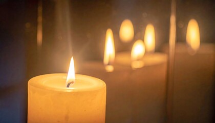 Glowing Wax Candle Flame Reflections on Glass in Dim Light Warm Atmosphere