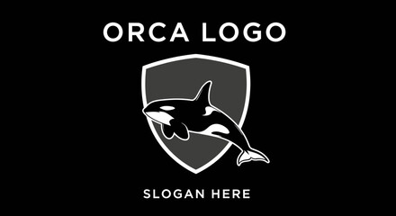 A stylized black and white logo featuring an orca whale swimming within a shield emblem, with "ORCA LOGO" and "SLOGAN HERE" text. © Yahya