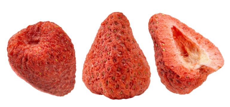 Three pieces of dried strawberries, one whole, one pointy, and a cross-section, showcasing their porous, crunchy texture and vibrant red color.