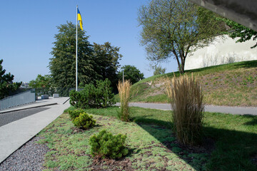 road in the park. The flag of Ukraine flutters in the blue sky