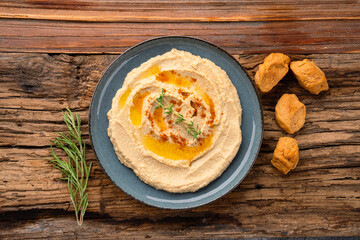 A traditional dish or appetizer hummus or baba ghanoush on wooden background	
