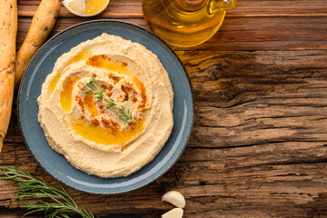 A traditional dish or appetizer hummus or baba ghanoush on wooden background	
