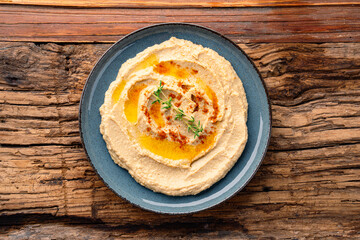 A traditional dish or appetizer hummus or baba ghanoush on wooden background	

