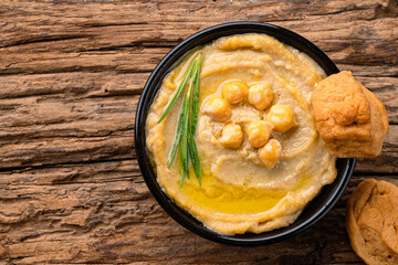 A traditional dish or appetizer hummus or baba ghanoush on wooden background	
