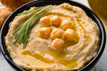  A traditional dish or appetizer hummus or baba ghanoush on white wooden background